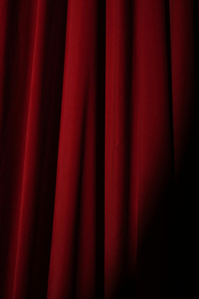 Deep red velvet theater curtain, perfect for presentations or artistic backgrounds.